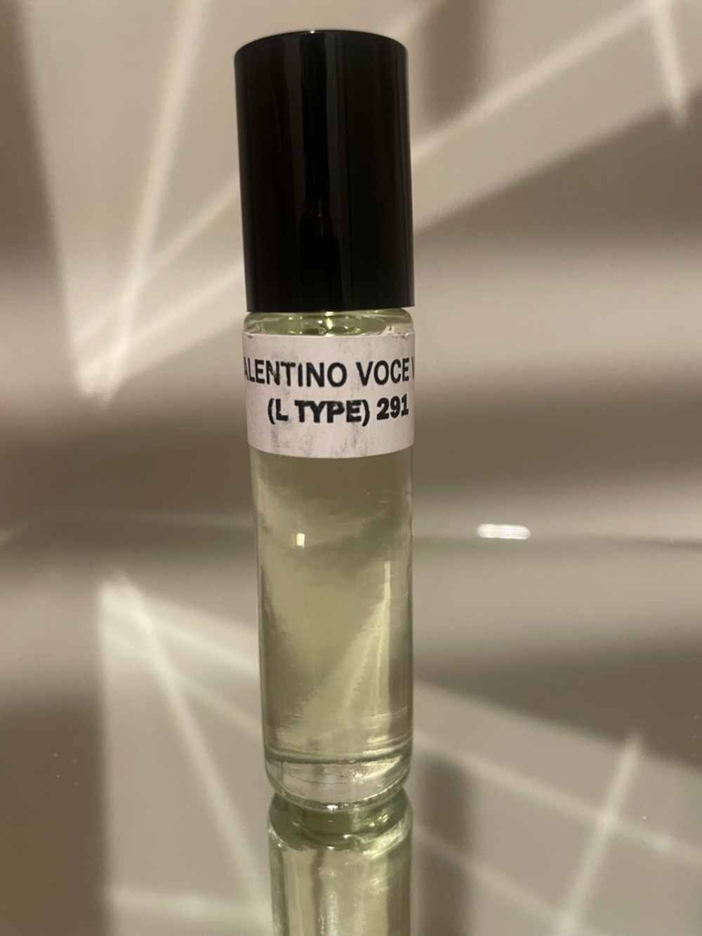 Valentino roller perfume vial in light green with black cap